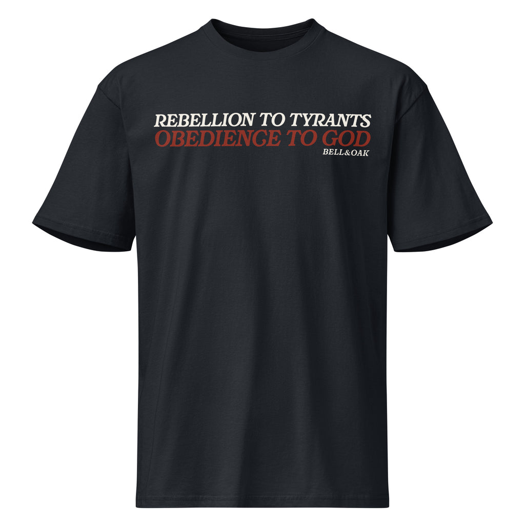Graphic navy blue t-shirt featuring the phrase "Rebellion to Tyrants Is Obedience to God" in a timeless American heritage design