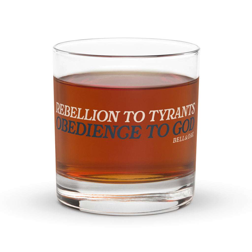Whiskey glass featuring the phrase "Rebellion to Tyrants Is Obedience to God" with vintage American heritage artwork